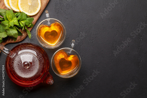 Herbal tea with mint and lemon. Tea cup and teapot