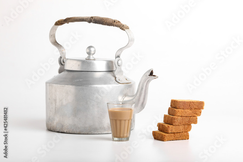 фотографія aluminum tea pot or kettle with rusk on white background.