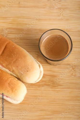 Famous breakfast. Tea and Bun on wooden background