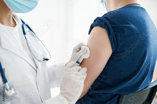woman doctor giving an injection in the shoulder Patient laboratory assistant vaccine