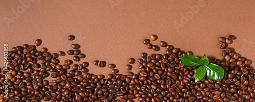 Roasted brown coffee beans. Top view. Brown coffe background. Banner.