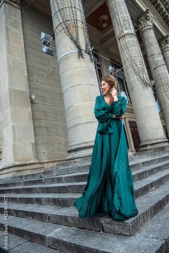full length young elegant woman in beautiful green gress standing in stone   stair © RomanR