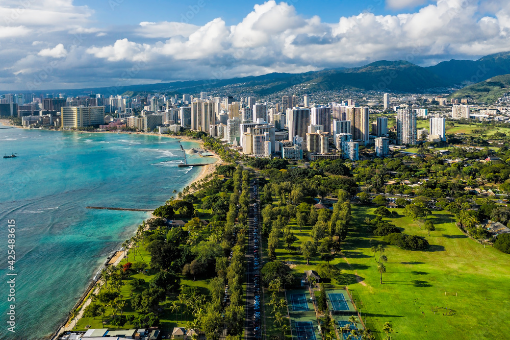 Aerial view of Waikiki with park district leading to Honolulu city. Afternoon light. Oahu Island, Hawaii