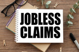 jobless claims. text on white paper on wood table background