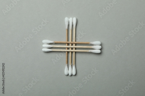 Wooden cotton swabs on light gray background  top view