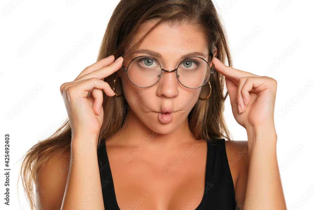 a young funny woman with blue eyes and glasses making fish face
