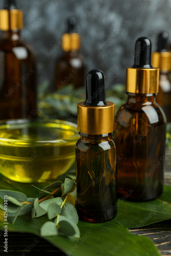 Concept of natural cosmetics with eucalyptus oil on wooden table Concept of natural cosmetics with eucalyptus oil on wooden table