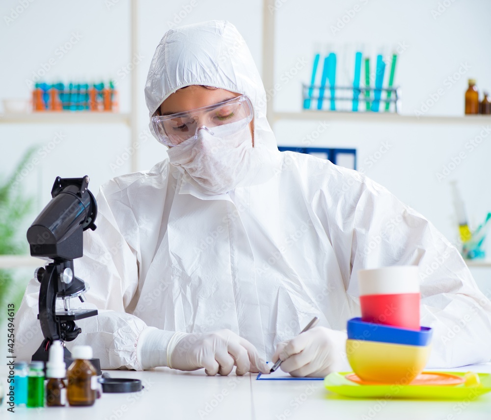 Chemist checking and testing plastic dishes Chemist checking and testing plastic dishes