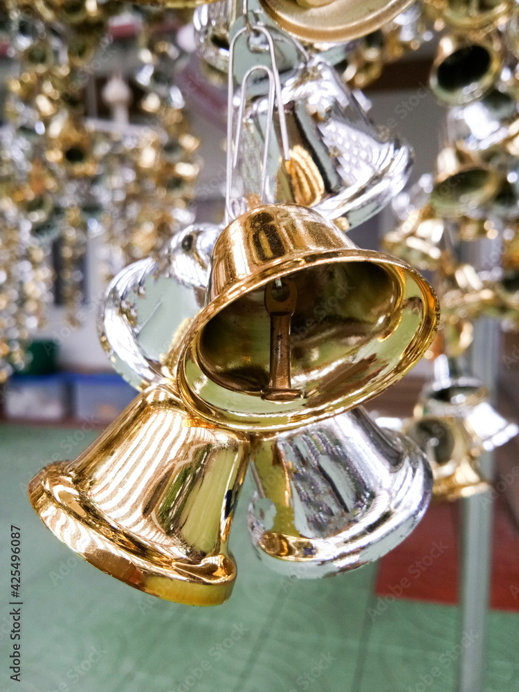 Lots of silver and gold bells for making merit at a Thai temple.