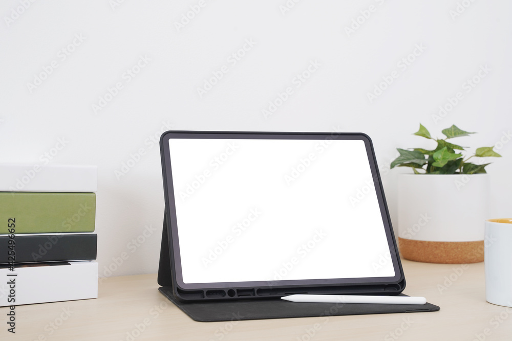 Blank screen tablet with digital pencil on the table. Blank screen tablet with digital pencil on the table.