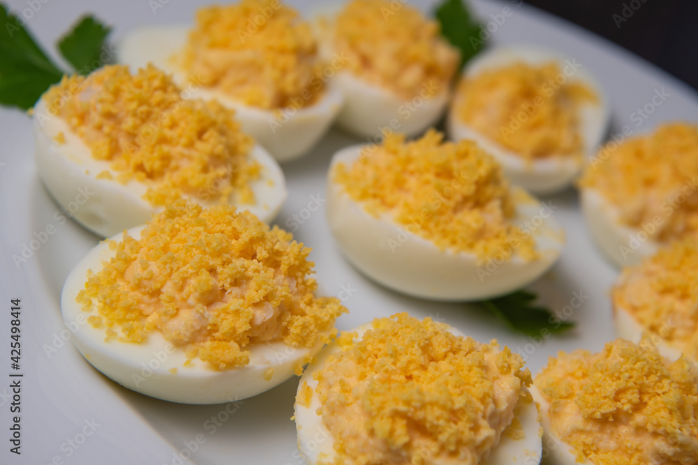Stuffed eggs with crab crumbs, mayonnaise and parsley macro on a plate, High quality photo Stuffed eggs with crab crumbs, mayonnaise and parsley macro on a plate, High quality photo