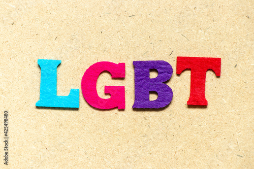Color cloth alphabet letter in word LGBT (Abbreviation of lesbian, gay, bisexual, and transgender) on wood background