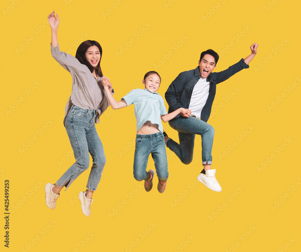 Happy young family with one child jumping together