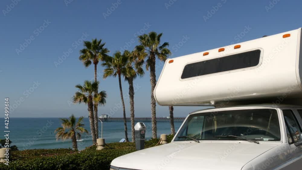 Motorhome trailer or caravan for road trip. Waterfront tropical palm