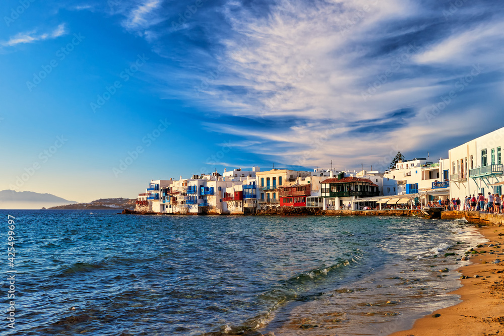 Beautiful Little Venice, Mykonos, Greece. Romantic neighborhood with whitewashed bars, cafes, restaurants. Sunset sky and clouds.