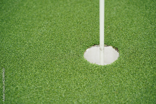 Golf hole and flag with the green grass, Selective focus.