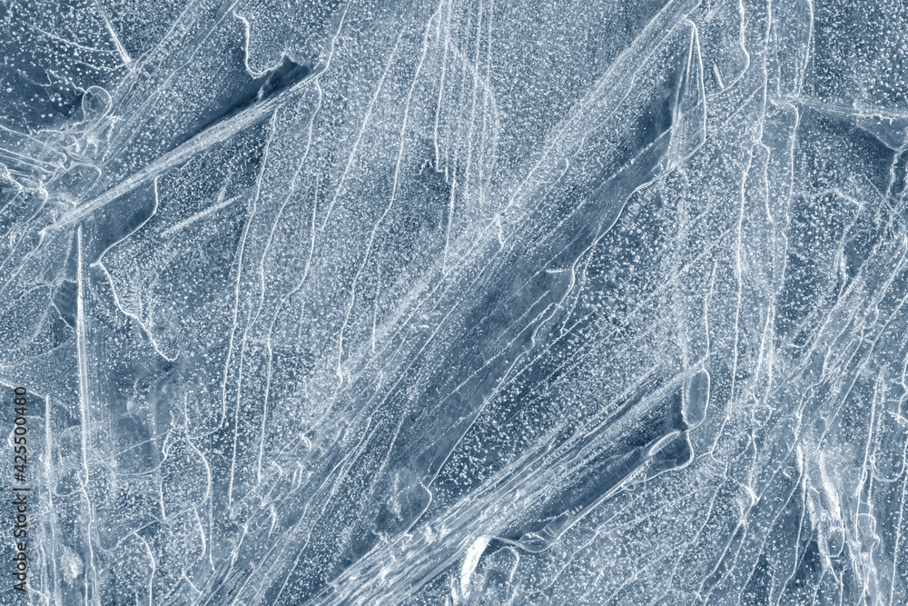 Obraz premium Ice background texture. Frozen water in various geometric abstract shapes. Seasonal natural effect. Cold weather. The surface of the winter water reservoir.