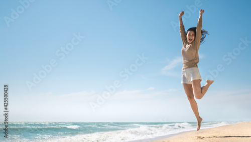Summer relaxation and vacation concept with copy space, Happy carefree asian female smiling jump on beach