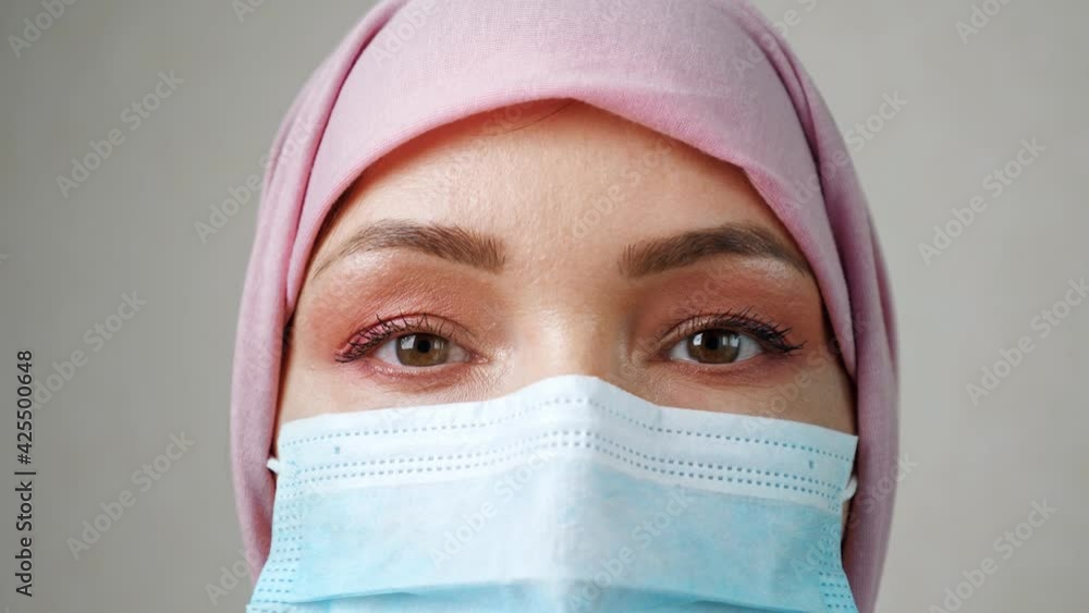 Young woman wearing hijab and medical mask. Young woman wearing hijab and medical mask.
