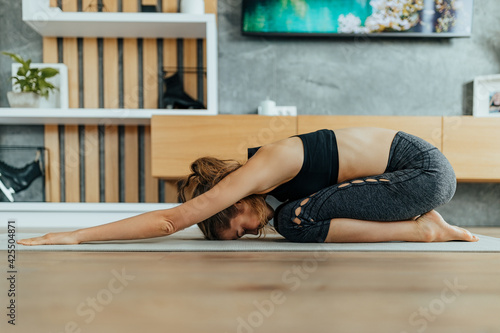 Practicing yoga, stretching. © bnenin