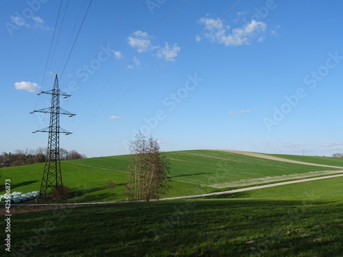 power lines on a field with beautiful sky background
