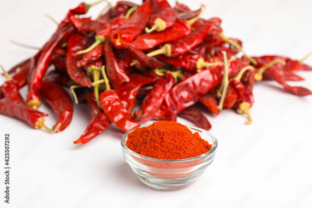 Dried red chilli and powder in glass bowl on white background. Dried red chilli and powder in glass bowl on white background.