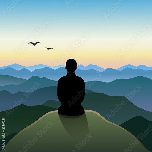silhouette of a person sitting on a rock looking to mountains and sunset or sunrise 