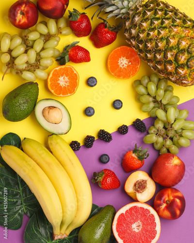 Exotic fruits on bright backgrounds. Pineapple, avocado, citrus fruits, berries on colored backgrounds. Bright and juicy fruits