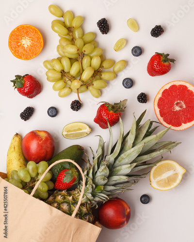 Exotic fruits on bright backgrounds. Pineapple, avocado, citrus fruits, berries on colored backgrounds. Bright and juicy fruits