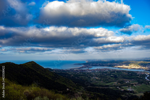 Sea view with large beach and blue sky and mountains