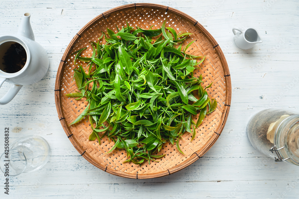 Green tea leaves in a wooden tray Green tea leaves in a wooden tray