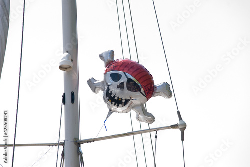 pirate balloon in the mast of a ship, against white sky