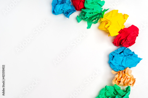 Crumpled paper of different colors on a white background. Creative concept of finding ideas and inspirations