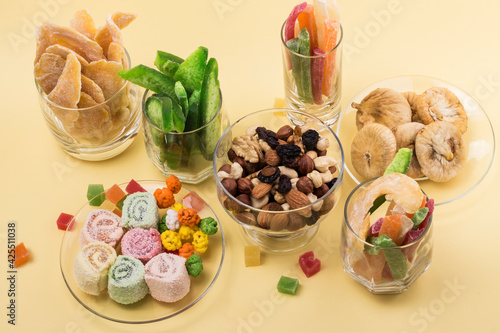 a variety of traditional oriental sweets on a yellow background, top view