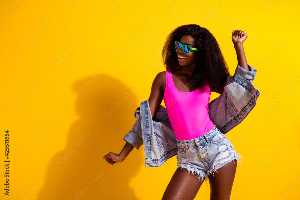 Obraz premium Photo of attractive funny afro american woman copyspace dance wear sunglass summer isolated on yellow color background