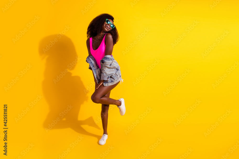 Full length photo of dark skin happy lady look empty space good mood summer isolated on shine yellow color background