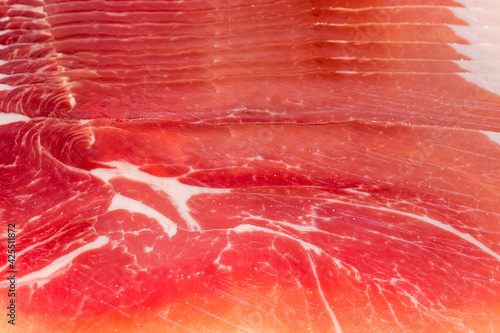 Thin slices of jamon close-up, background, texture