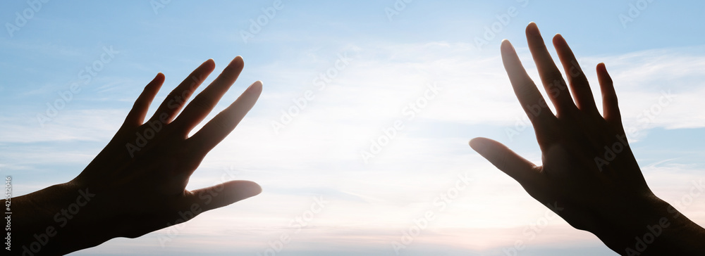 Hands reaching to the sky blinded by the light. Faith concept Hands reaching to the sky blinded by the light. Faith concept
