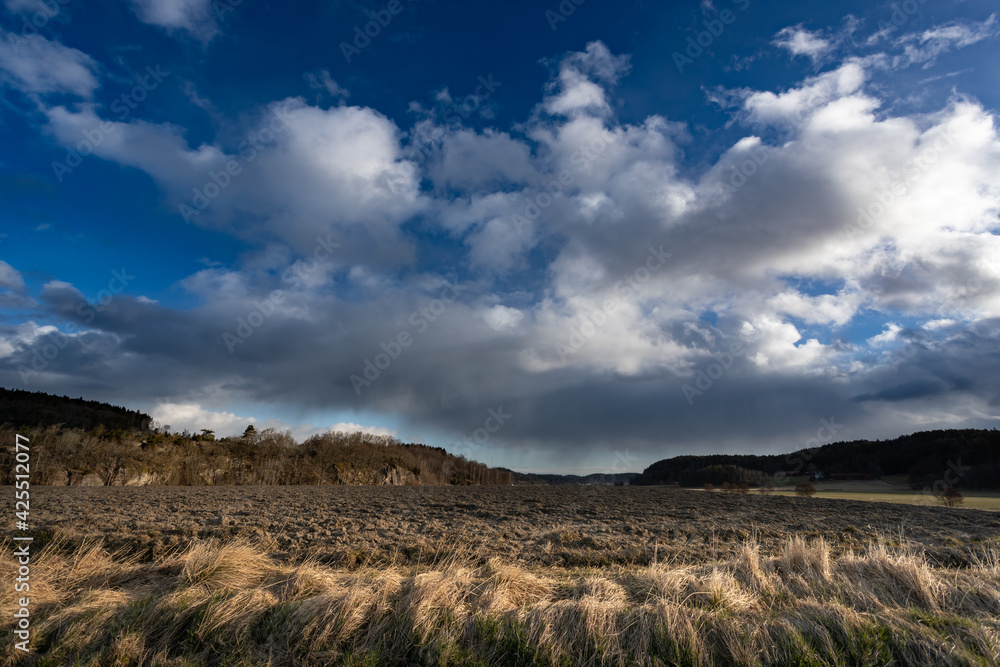 Rural landscape with plowed field and dramatic clouds. Shot in Sweden, Scandinavia