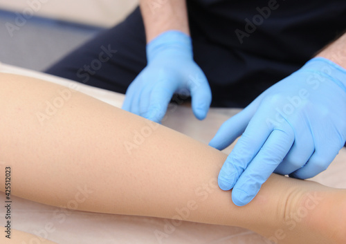 Doctor examines varicose veins on a woman s legs