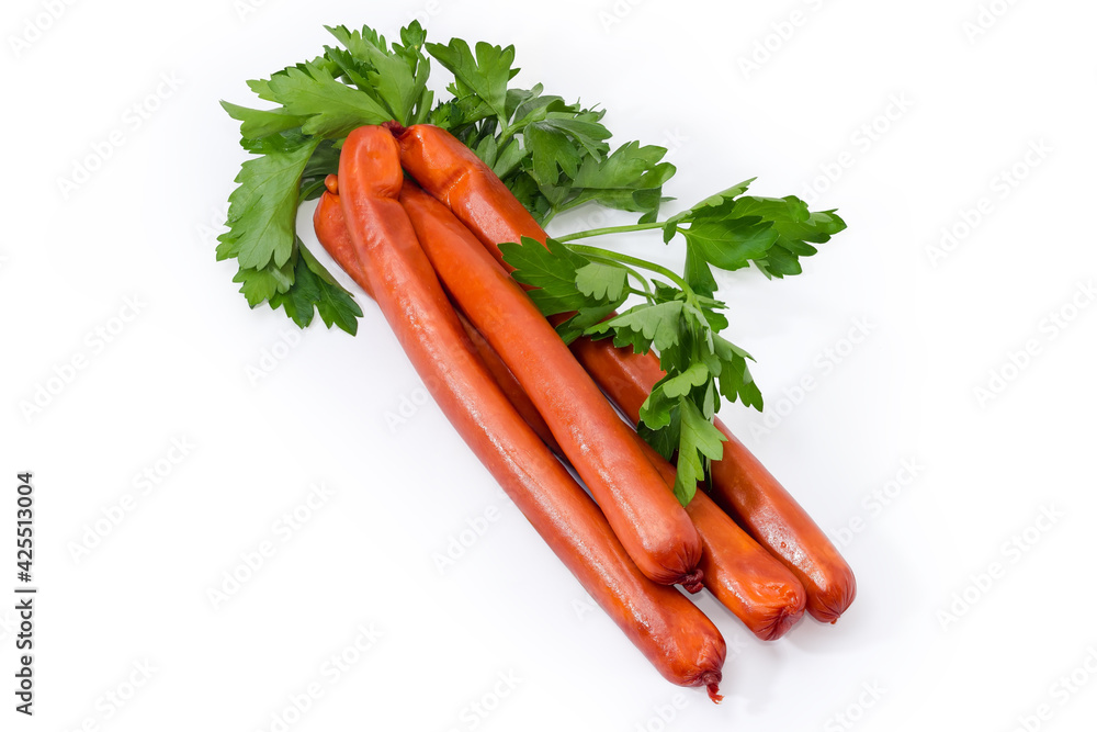 Long thin smoked sausages with parsley twigs on white background Long thin smoked sausages with parsley twigs on white background