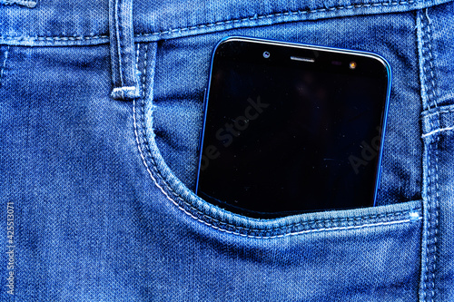 mobile phone in jeans pocket