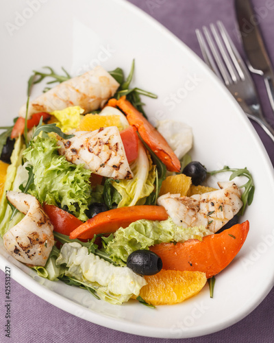 Fresh salad with vegetables and meat. Seafood and greens. Restaurant menu