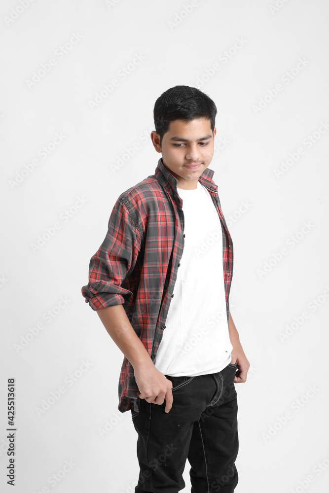 Young indian boy in a casual outfit and showing expression on white background. Young indian boy in a casual outfit and showing expression on white background.