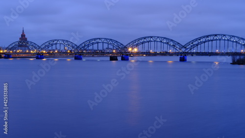 Cloudy morning, clouds over the Daugava in Riga, railway bridge in the lights