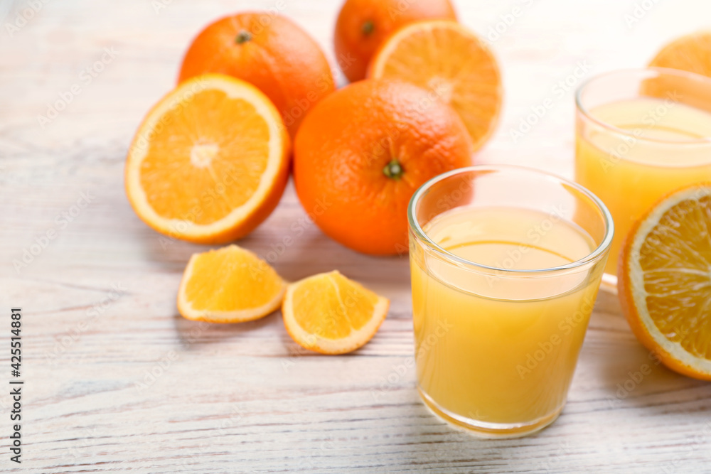 Delicious orange juice and fresh fruits on white wooden table. Space for text Delicious orange juice and fresh fruits on white wooden table. Space for text