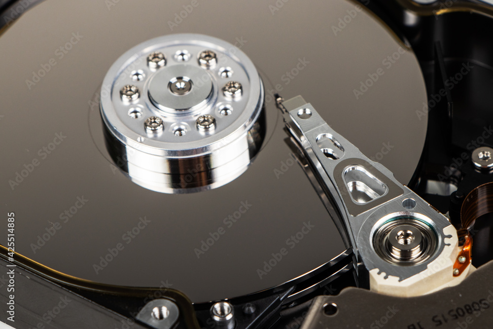 Disassembled hard drive from the computer, hdd with mirror effect. Opened hard drive from the computer hdd with mirror effects. Part of computer pc, laptop. Disassembled hard drive from the computer, hdd with mirror effect. Opened hard drive from the computer hdd with mirror effects. Part of computer pc, laptop.