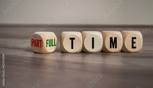 Cubes, dice or blocks with full-time or part-time on wooden background photo