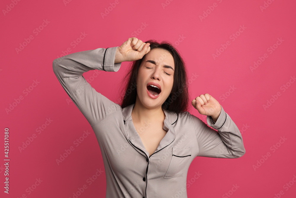 Young tired woman yawning on pink background Young tired woman yawning on pink background