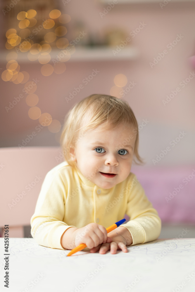 Baby draws at the table Baby draws at the table
